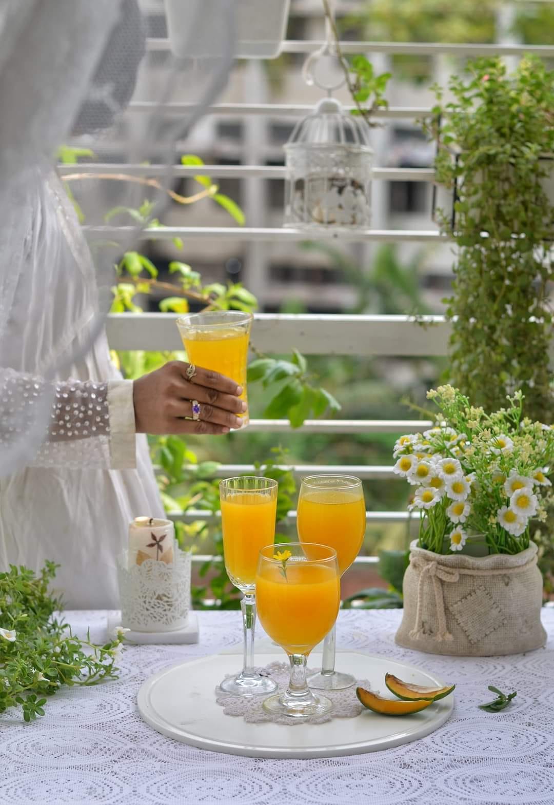 A woman holding a glass of melon juice